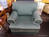 SAGE GREEN ARMCHAIR; GREEN LINEN AND WHITE PIPING ARMCHAIR WITH SKIRT. MEASURES APPROXIMATELY 42 IN