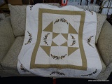 HANDMADE QUILT; OFF WHITE BACKGROUND. FEATURES FALL NEEDLE POINT ACCENTS OF PINECONES, BERRIES, AND