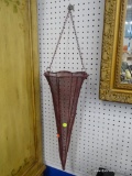 TRUMPET SHAPED HANGING BASKET; PLANTER MADE OF MAROON WIRE MESH WITH A BRAIDED SCALLOPED EDGE.