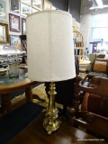 BRASS TABLE LAMP; BRASS TABLE LAMP WITH THREE TRUMPET STYLE FEET AND A BEIGE TEXTURED, CREAMER DRUM