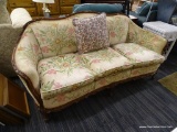 VINTAGE CAMELBACK SOFA; FEATURES ROUNDED ARMS, CREAM UPHOLSTERY WITH PINK, ORANGE, YELLOW, AND GREEN