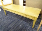 WOODEN COFFEE TABLE; FEATURES A YELLOW TINTED STAIN, A RECTANGULAR TOP, AND FOUR, BEVELED, TAPERED