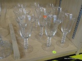 PARTIAL SHELF LOT OF GLASS DRINKWARE; THIS 9 PIECE LOT INCLUDES 9 STEMMED WATER GLASSES. ONE GLASS