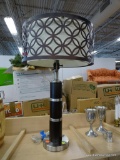 TABLE LAMP; FEATURES A CIRCULAR BRUSHED SILVER BASE, A DARK WOOD BODY, AND A SHORT CREAM COLORED