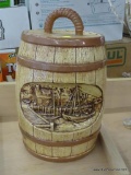 BARREL COOKIE JAR; CERAMIC COOKIE JAR RESEMBLING A BARREL WITH A DEPICTION OF A SAILBOAT AND BOAT