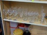 PARTIAL SHELF LOT OF DRINKING GLASSES; INCLUDES AN ASSORTMENT OF STEMMED DRINKING GLASSES AND SINGLE