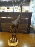 GIRAFFE SCULPTURE; WOODEN GIRAFFE SCULPTURE DEPICTING A BABY GIRAFFE NURSING FROM ITS MOTHER.