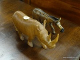 WOODEN ANIMAL FIGURINES; INCLUDES A RHINOCEROS AND A ZEBRA. LARGEST MEASURES 8 IN X 4 IN.
