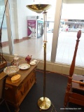 BRASS FLOOR LAMP; FEATURES A CIRCULAR BASE WITH A FOLDABLE GLOBE ON AN ADJUSTABLE ARM. MEASURES 69.5