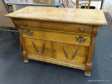 ANTIQUE WASHSTAND; ANTIQUE OAK WASHSTAND WITH 3 DRAWERS OVER 2 DOORS. HAS APPLIED LEAF PATTERN ON