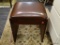 LEATHER UPHOLSTERED STORAGE STOOL; FEATURES A SQUARE, LEATHER UPHOLSTERED SEAT THAT LIFTS TO REVEAL