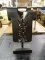 METAL DECOR; BRUSHED BLACK AND COPPER METAL DECORATION THAT RESEMBLES A COLLARED SHIRT WITH ORNATE