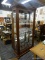 PULASKI FURNITURE LIGHTED CURIO CABINET; FEATURES A BEVELED GLASS FRONT, ROUNDED AND GROOVED SIDE