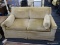 YELLOW LOVESEAT; FEATURES YELLOW, VELVET UPHOLSTERY WITH TWO ARM PILLOWS AND RAISED BORDER ON BACK