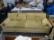 YELLOW COUCH; FOUR CUSHION COUCH FEATURING YELLOW, VELVET UPHOLSTERY WITH TWO ARM PILLOWS AND RAISED