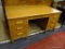 VINTAGE WOOD DESK; HAS 6 DOVETAIL DRAWERS. 6 WOOD HANDLES. 1 DRAWER HOLDS FILES. 3 DRAWERS WITH