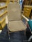 TAN FOLDING OUTDOOR CHAIR; VINTAGE WOVEN CHAIR. TAN IN COLOR WITH PLASTIC ARMRESTS. MEASURES 23.5 IN