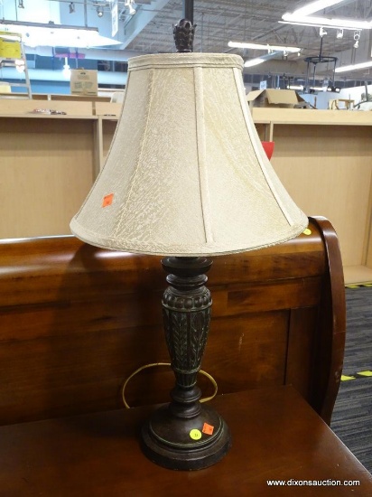 TABLE LAMP; FEATURES A DECORATIVE METAL FINIAL, BELL SHAPE TEXTURED TAUPE LAMP SHADE, LEAF DETAILS,