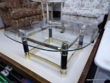 GLASS TOP COFFEE TABLE; HAS GOLD AND BLACK BASE WITH STRETCHER BASE. MEASURES 36 IN X 36 IN X 16 IN