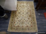 AREA RUG; FLORAL PATTERN AREA RUG IN TONES OF GREEN, PINK, AND TAN. FROM THE CLASSIC WOOL