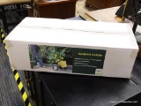 GARDEN CADDY; METAL FRAME GARDEN CADDY IN ORIGINAL, UNOPENED BOX. FEATURES A BUCKLE FOR SECURING
