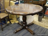 RUSTIC ROUND DINING TABLE; FEATURES A CIRCULAR TOP THAT APPEARS SCALLOPED DUE TO THE WAY IT IS