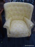 FLORAL UPHOLSTERED ARM CHAIR; FEATURES YELLOW UPHOLSTERY WITH GREEN AND CORAL FLORAL DESIGNS. HAS