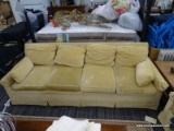 YELLOW COUCH; FOUR CUSHION COUCH FEATURING YELLOW, VELVET UPHOLSTERY WITH TWO ARM PILLOWS AND RAISED