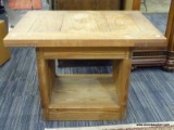 WOODEN SIDE TABLE; FEATURES A RECTANGULAR TOP AND TWO OPEN SIDES CONNECTED TO A RECTANGULAR BASE.