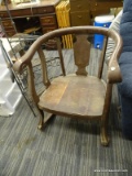 ROUND BACK ROCKER; DARK STAINED, LOW PROFILE WOODEN ROCKER WITH A ROUNDED BACK, SCROLLED ARMS, AND