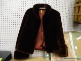 FAUX FUR JACKET; DARK BROWN FUR JACKET WITH OVERSIZED CUFFS AND COLLAR. FEATURES TWO BUTTONS, A SILK