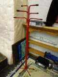 RED METAL COAT RACK; FEATURES A BUNDLED RED METAL FRAME WITH BLACK NON-SLIP ENDS. MEASURES 60.5 IN