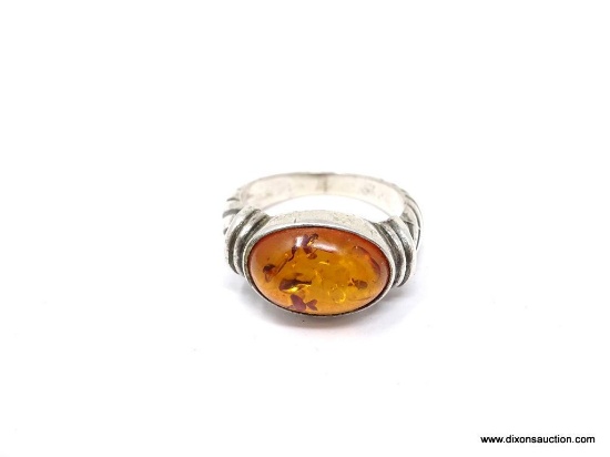 .925 AND AMBER RING; BEAUTIFUL .925 AND AMBER RING. CABLE DESIGN ON BAND. THE AMBER MEASURES 5/8" X