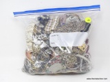 BAG LOT OF COSTUME JEWELRY; LOT CONTAINS ASSORTED NECKLACES, BRACELETS, AND EARRINGS.