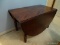 (UPBR2) DROPSIDE TABLE; HAS TURNED LEGS AND IS IN GOOD USED CONDITION. WITH DROP SIDES DOWN MEASURES