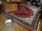 (FAM) AREA RUG; PERSIAN AREA RUG IN REDS, BLUES, IVORY, AND GREEN. IS IN GOOD CONDITION WITH NO