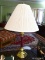 (KIT) TABLE LAMP; BRASS AND BURGUNDY TONED TABLE LAMP WITH PLEATED CLOTH SHADE AND FINIAL. MEASURES