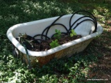 (OUT) VINTAGE TUB; CAST IRON TUB WITH AN OUTDOOR WATER HOSE. MEASURES 60 IN X 26 IN X 16 IN. PLEASE