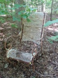 (OUT) METAL MESHED WIRE CHAIR; HAS SCROLLED ARMS. MEASURES 20 IN X 25 IN X 42 IN