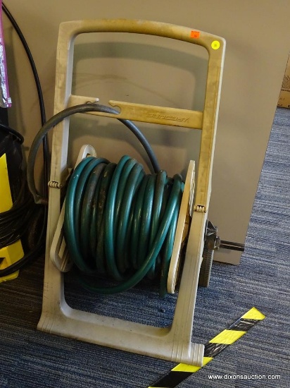 SUNCAST HOSE REEL; INCLUDES A HOSE. IS CREAM IN COLOR WITH GREEN HOSE. IS IN GOOD USED CONDITION.