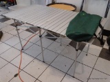 ROLL-UP CAMPING TABLE; ALUMINUM SLAT STYLE TABLE WITH POP OPEN BASE. TOP UNROLLS AND CLICKS INTO