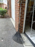 OUTDOOR RAKE; METAL HANDLE RAKE WITH WIDE BLACK PLASTIC RAKE HEAD. MEASURES 2 FT ACROSS X 5 FT 5 IN