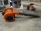 (GARAGE) HUSQVARNA LEAF BLOWER; ORANGE AND BLACK IN COLOR. HAS GOOD COMPRESSION. MODEL 125B