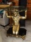 (FAM) EGYPTIAN FIGURAL TABLE; 1 OF A PAIR OF GOLD TONED AND BLACK PAINTED KNEELING EGYPTIAN FIGURAL