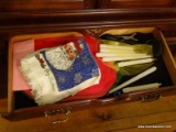 (DR) CONTENTS OF LOWER PORTION OF CHINA CABINET; CHRISTMAS TOWELS, CANDLES, CHRISTMAS PLACEMATS,