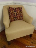 (LR) ARM CHAIR; BEIGE UPHOLSTERED ARM CHAIR WITH MAHOGANY LEGS AND A BROWN OVAL PATTERN ACCENT