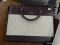 DAY RUNNER BRIEFCASE; BROWN FAUX LEATHER AND TAN DOUBLE HANDLED ZIPPERED BRIEFCASE. HAS LARGE POCKET