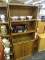 WOODEN BOOKCASE; HAS 3 UPPER SHELVES AND 2 LOWER DOORS WITH SPACES FOR ADJUSTABLE SHELVES. IS IN