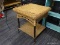 WICKER AND METAL END TABLE; HAS A LOWER SHELF AND IS IN VERY GOOD CONDITION. MEASURES 1 FT 9 IN X 1