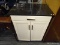 CROSLEY FURNITURE ROLLING MARBLE TOP COUNTER AND CONTENTS; BLACK MARBLE TOP COUNTER, WHITE BODY